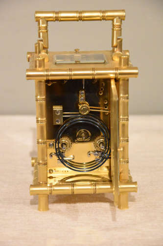 A rare porcelain mounted carriage clock in bamboo case