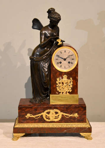 A French bronze and red marble mantel clock